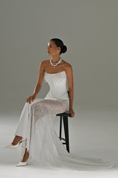 Satin mermaid wedding dress with lace side panels – model seated on a stool showing the lace panel