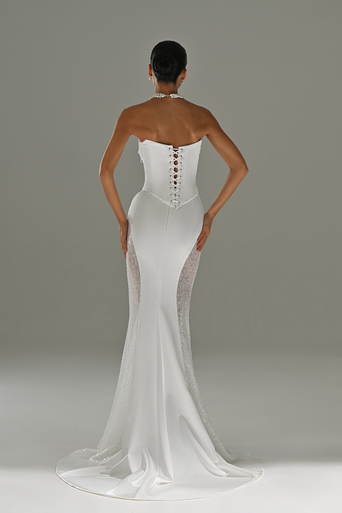 Satin mermaid wedding dress with strapless corset – back view of the lace-up corset back and train