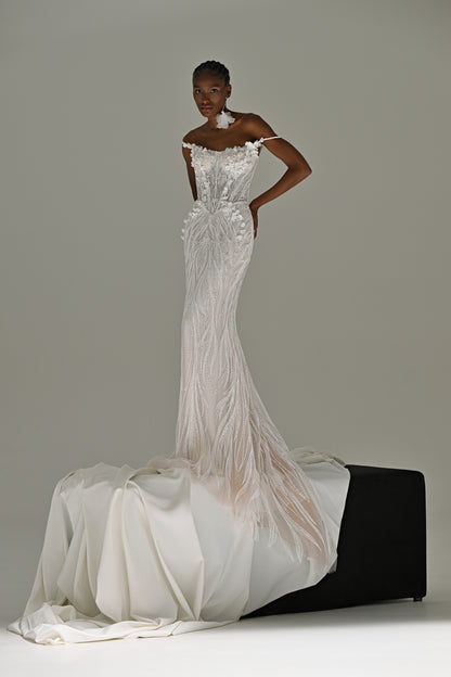 Lace mermaid wedding dress with fringe detail – standing front view, hand on hip, train over the block