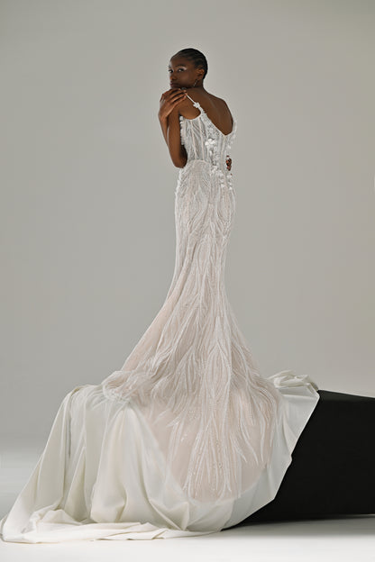 Lace mermaid wedding dress with fringe detail – front view with the train spread over a black block