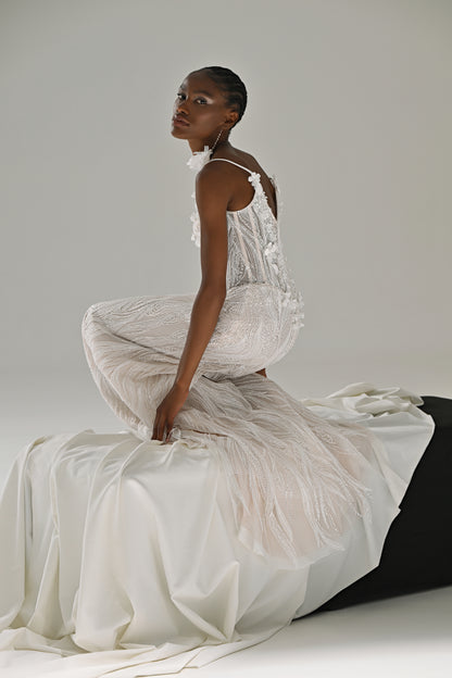Lace mermaid wedding dress – side view seated on the block with the fringe-trimmed skirt