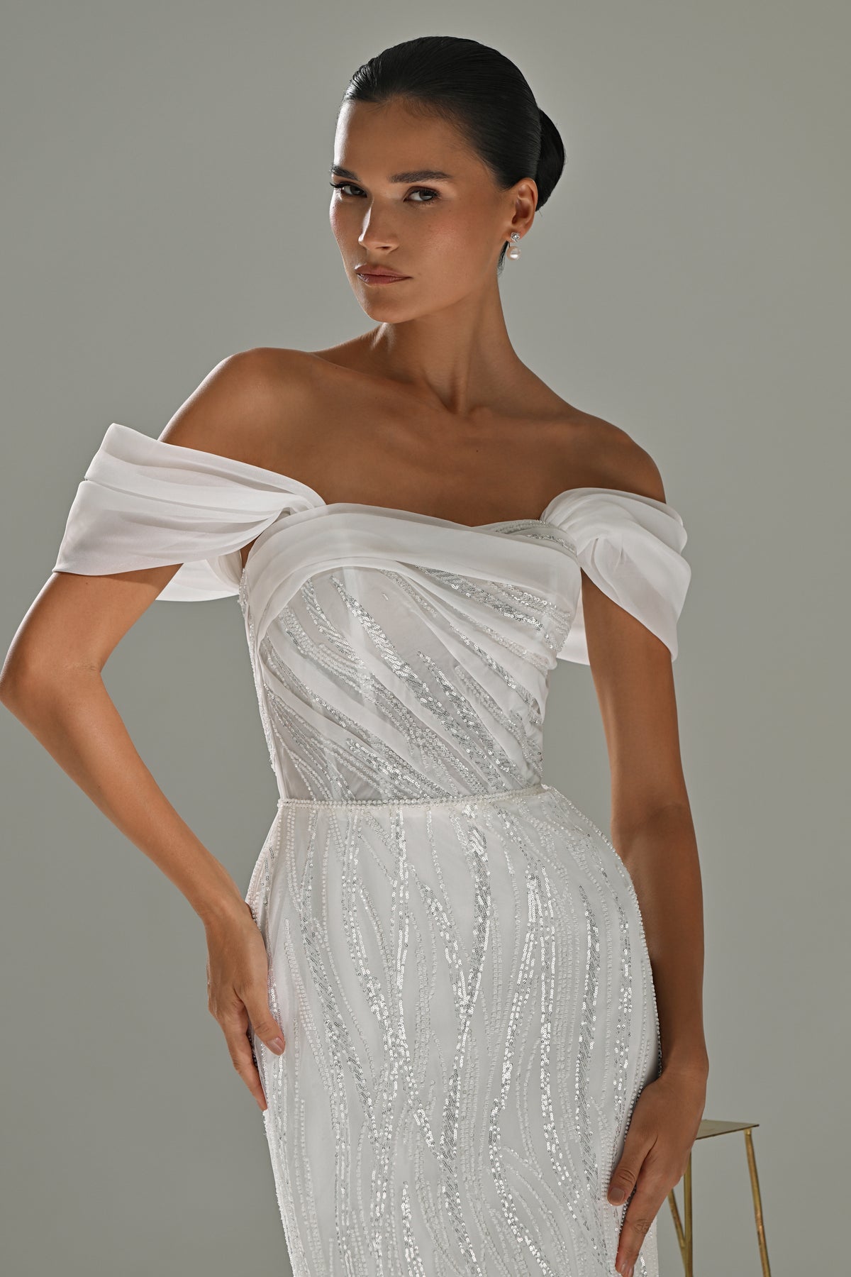 Lace mermaid wedding dress – close-up of the asymmetric off-shoulder drape and beaded bodice