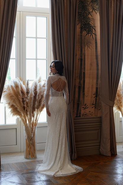 Sheath wedding dress with beaded lace and keyhole open back.