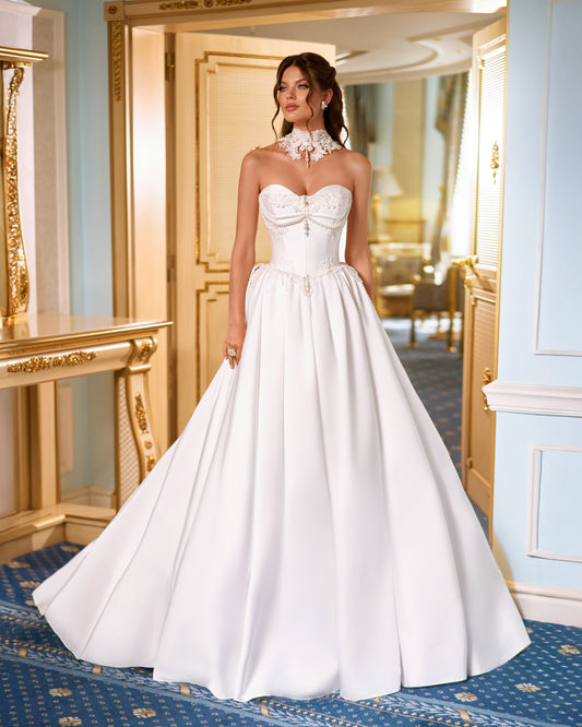 Strapless Mikado princess A-line wedding dress with sweetheart neckline, lace and pearl choker, lace-up closure, and chapel train.