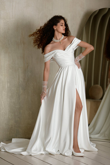 Satin A-line wedding dress with off-shoulder pleated bodice.