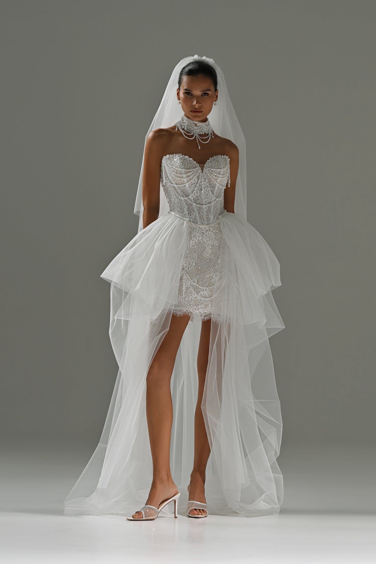Lace mini wedding dress with corset bodice – front view with the detachable tulle train and veil