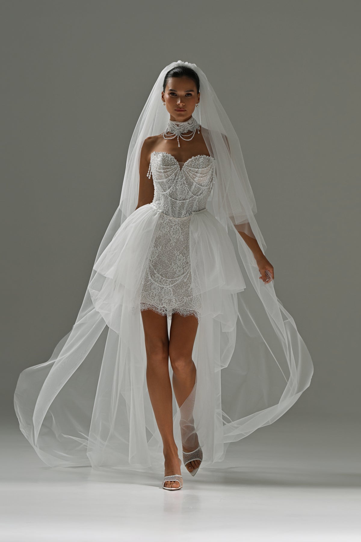 Lace mini wedding dress with sweetheart neckline – front view with the sheer tulle train trailing