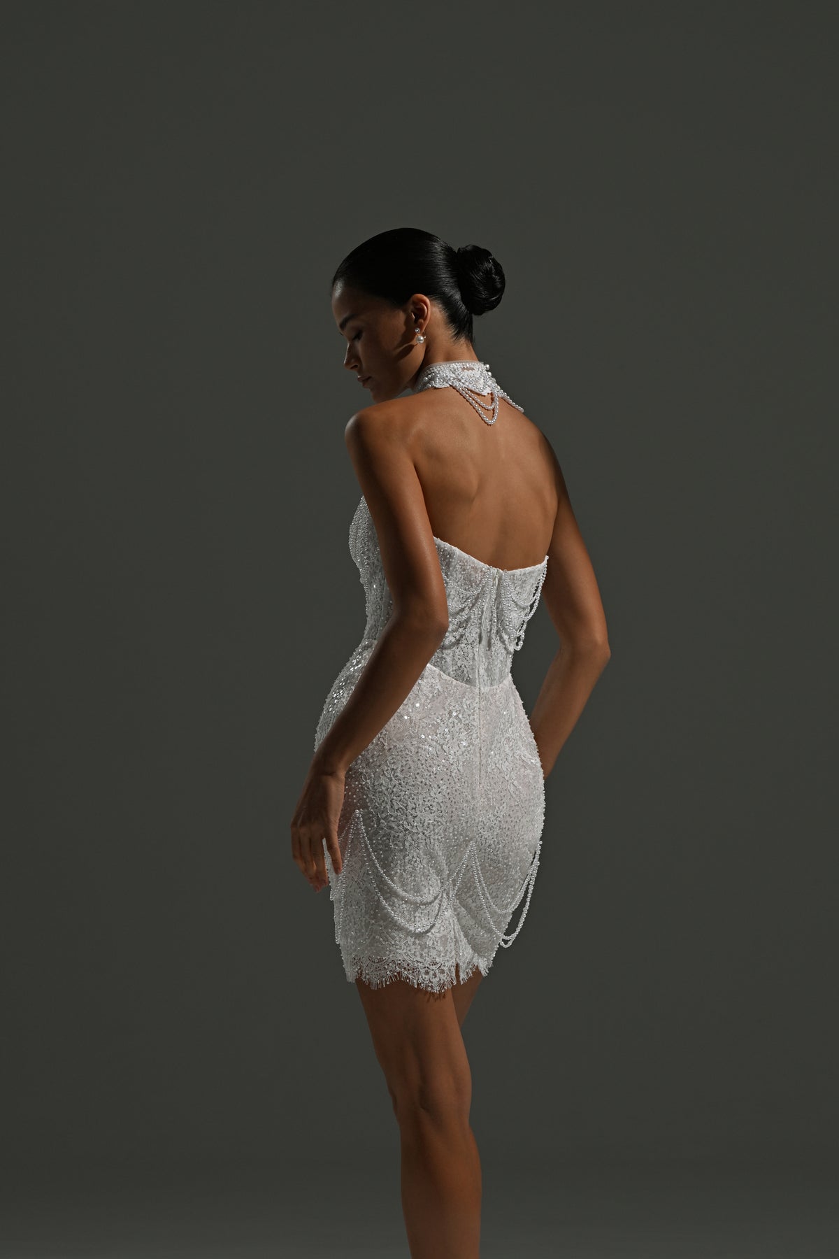 Lace mini wedding dress with corset bodice – back three-quarter view without the train