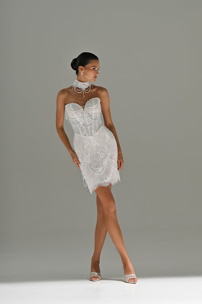Lace mini wedding dress with sweetheart corset – full-length front view, legs crossed