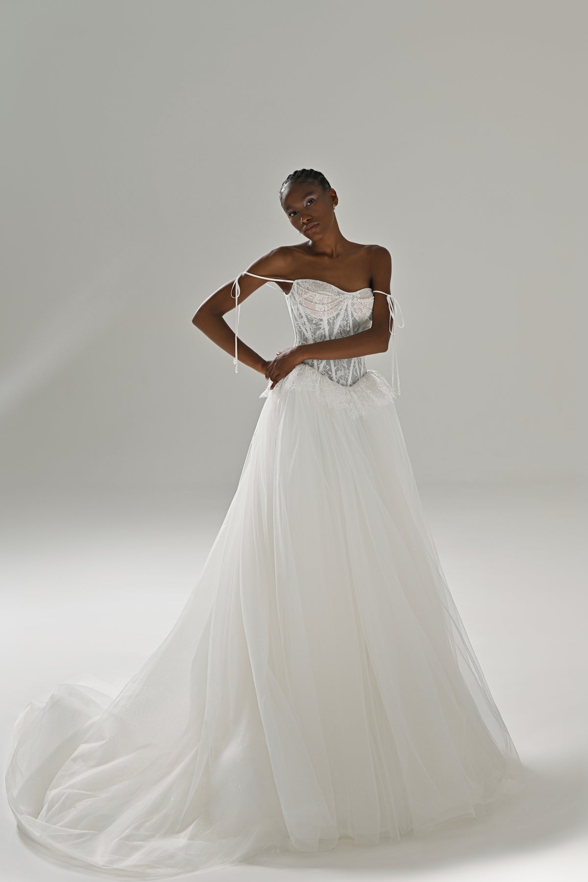 Lace and tulle ball gown wedding dress with peplum waist – full-length front view, hands on hips