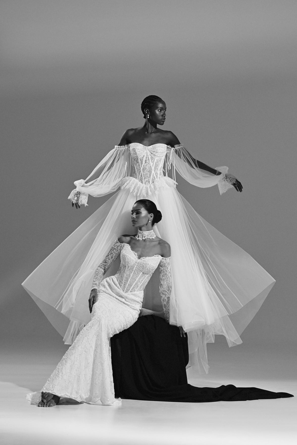 Lace and tulle ball gown wedding dress – black and white view of two brides with the tulle overskirt