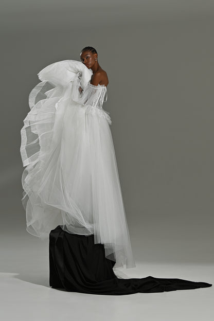 Lace and tulle ball gown wedding dress with oversized sleeves – tulle skirt draped over a black block