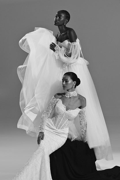 Lace mermaid wedding dress with tulle overskirt – black and white view of two brides