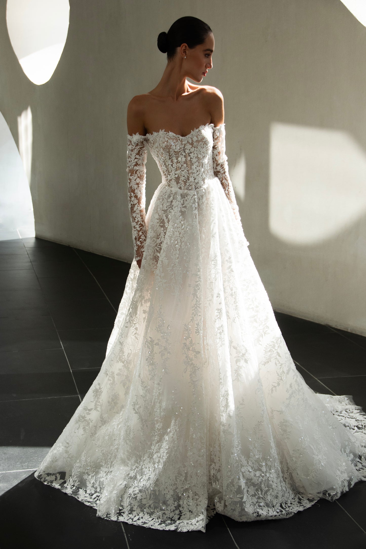 Celeste off-shoulder lace and tulle ball gown with detachable long sleeves and chapel train.