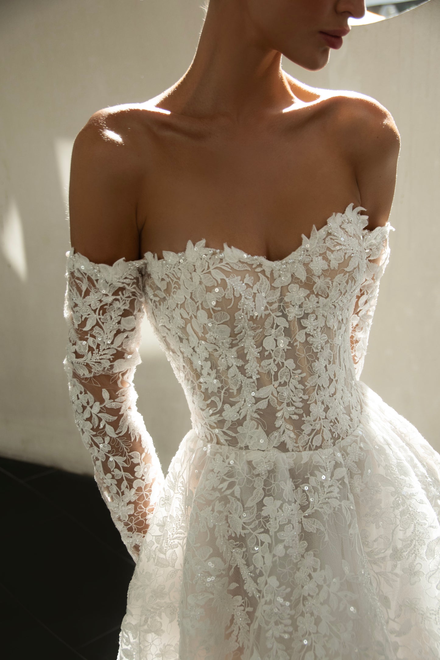Celeste off-shoulder lace and tulle ball gown with detachable long sleeves and chapel train.