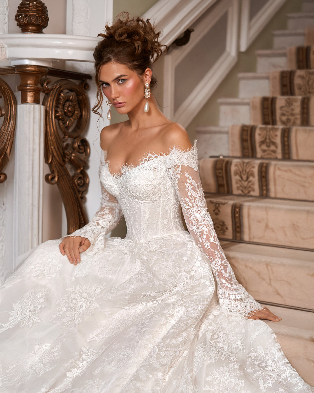 A-line lace wedding dress with a sweetheart corset, off-the-shoulder neckline and sheer long floral lace sleeves.