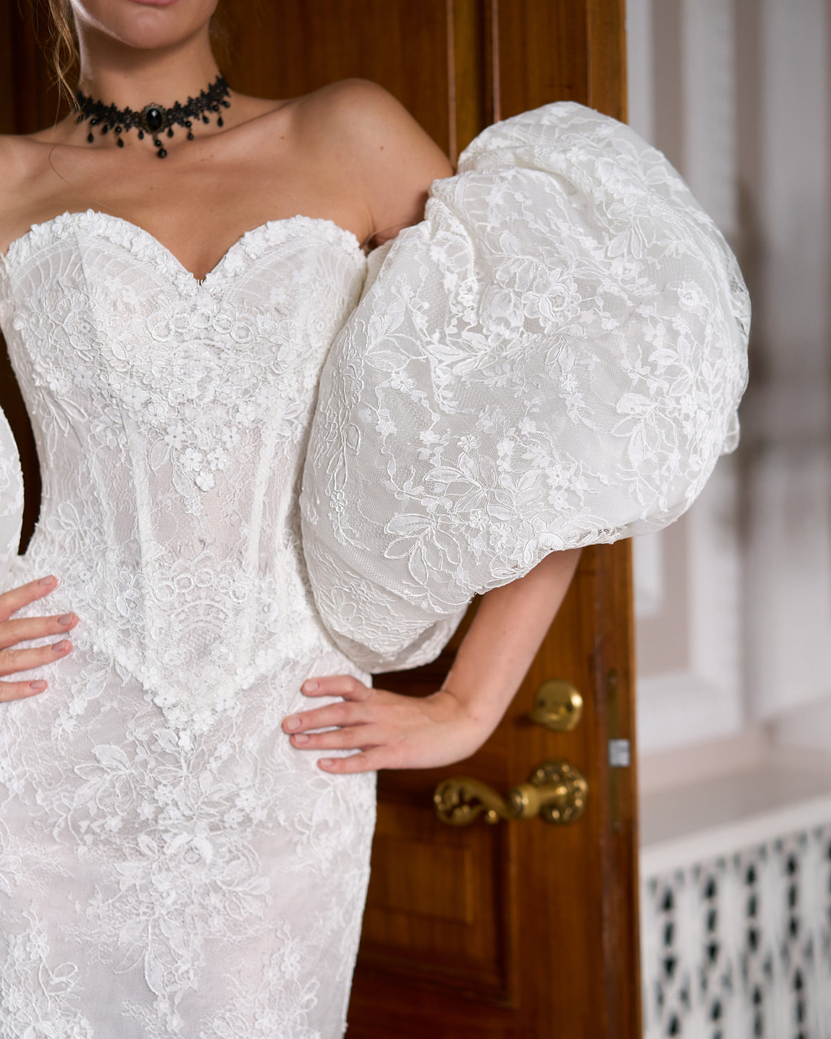Close view of voluminous lace puffy sleeve and corset bodice with 3D lace flowers
