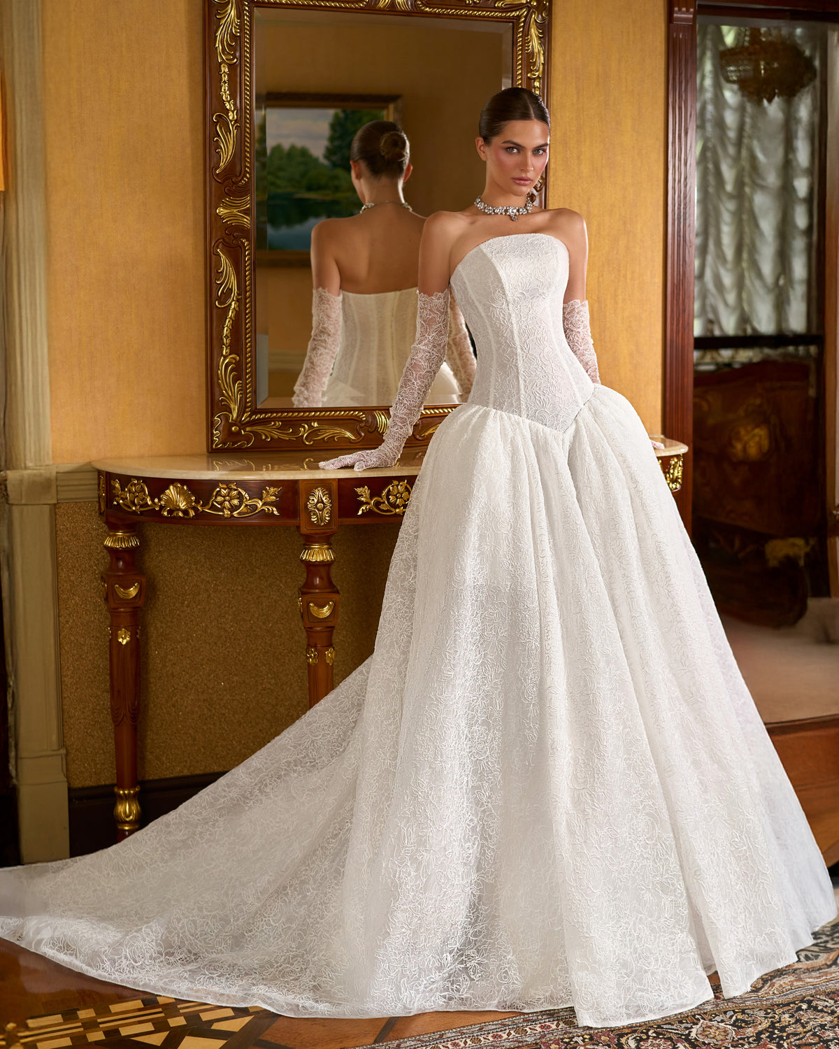 Lace ball gown wedding dress with drop-waist corset bodice, gathered hips and long lace gloves