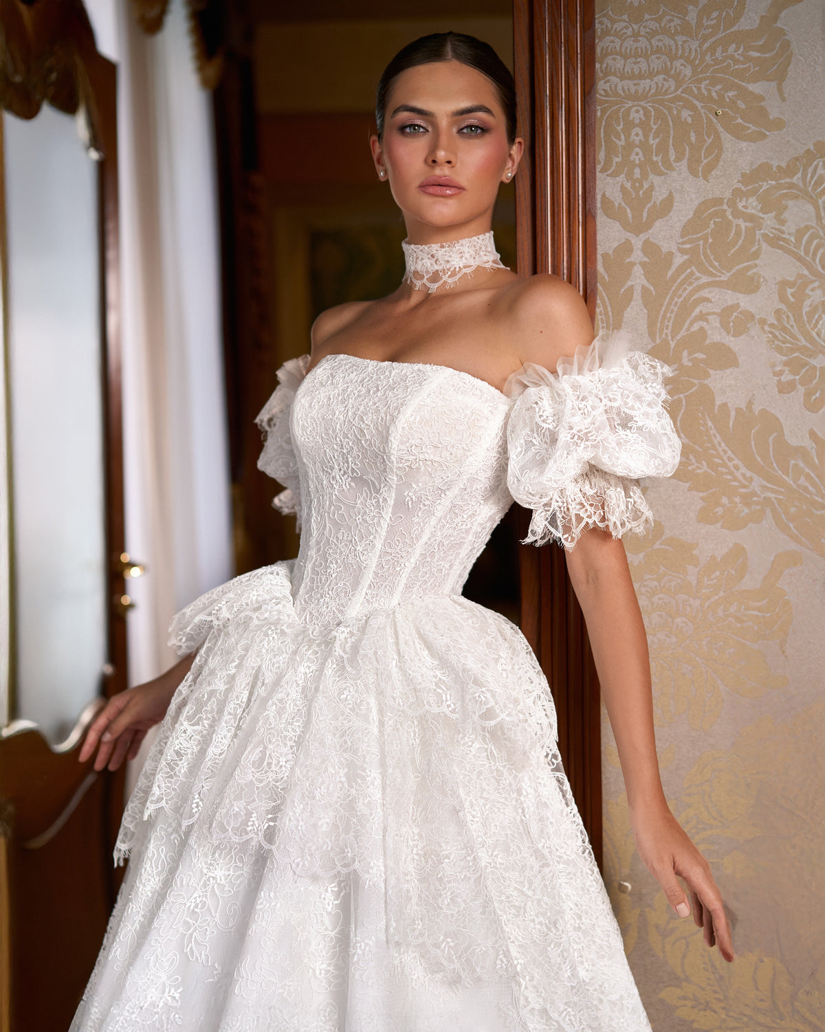Close view of corset bodice, scalloped lace peplum, puff sleeves and lace choker