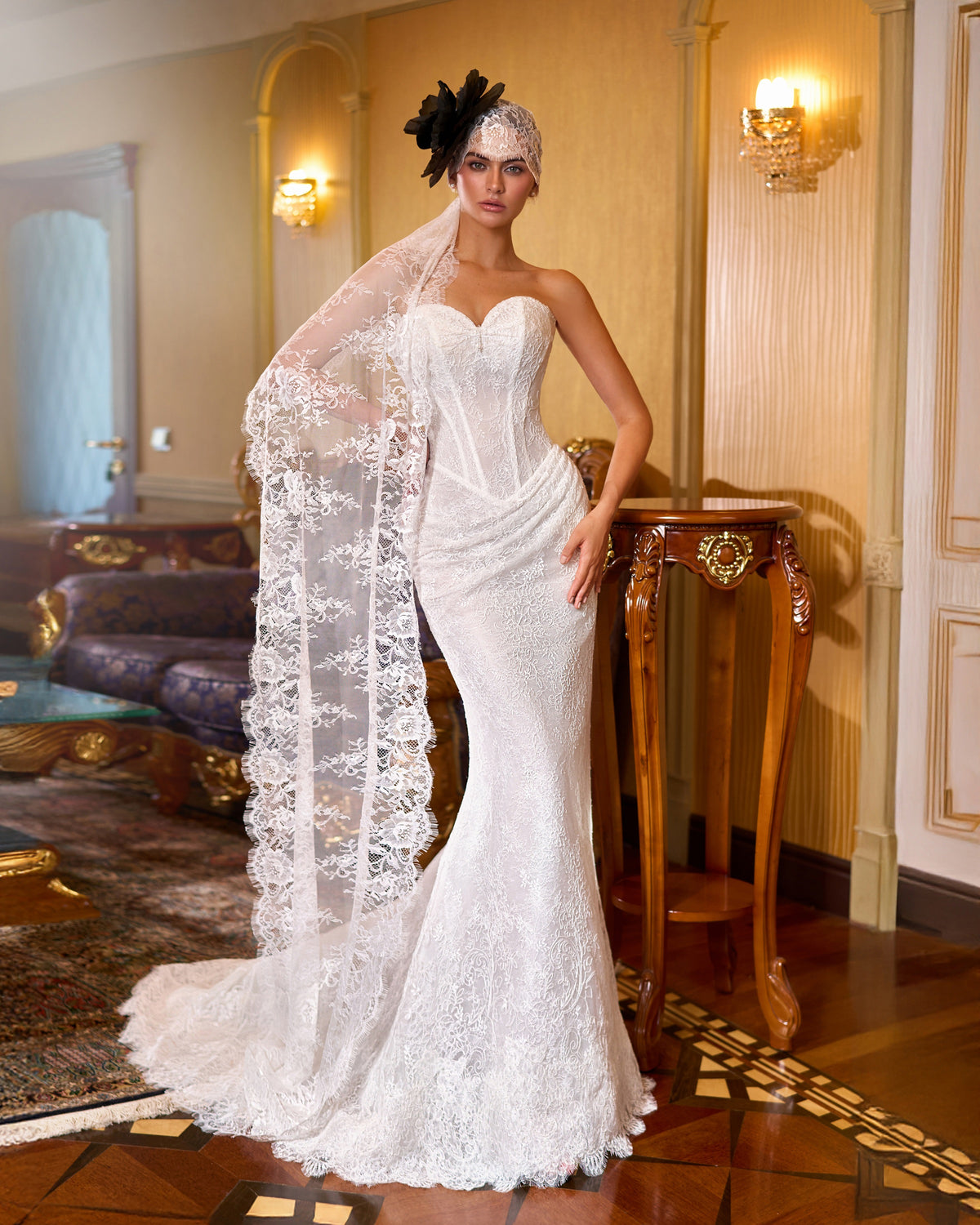 Mermaid wedding dress with floral lace, a strapless sweetheart corset, draped hips and a scalloped fishtail hem.