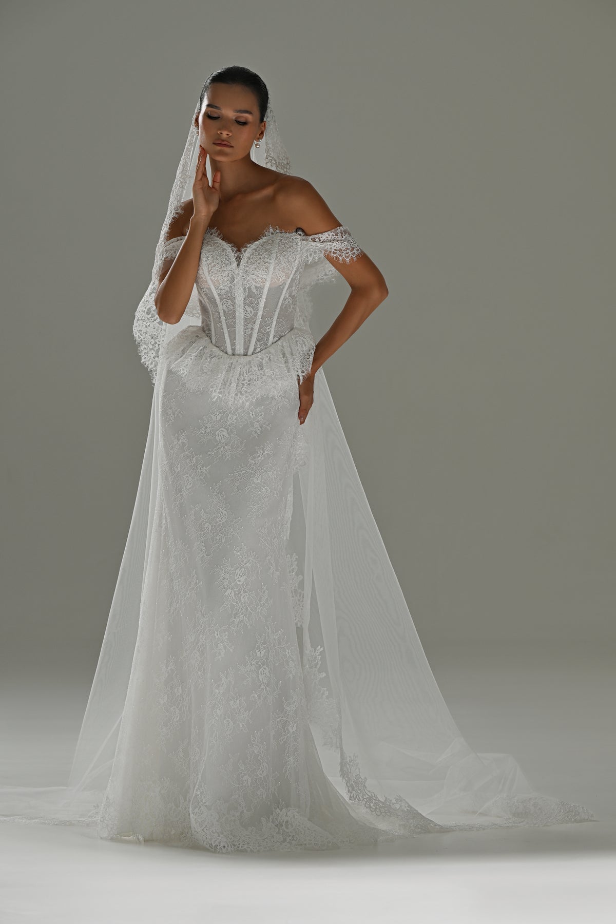 Lace mermaid wedding dress with off-shoulder sweetheart corset and cap sleeves – full-length front view with the overskirt