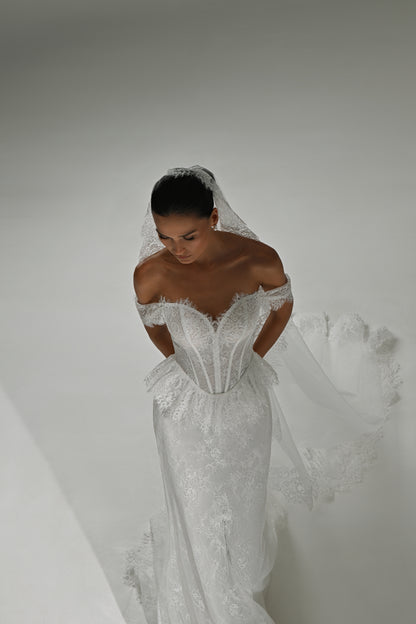 Lace mermaid wedding dress with off-shoulder sweetheart corset – high-angle view with the veil flowing