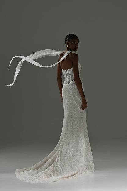 Lace mermaid wedding dress with scarf collar – back view with the scarf flying and the train on the floor