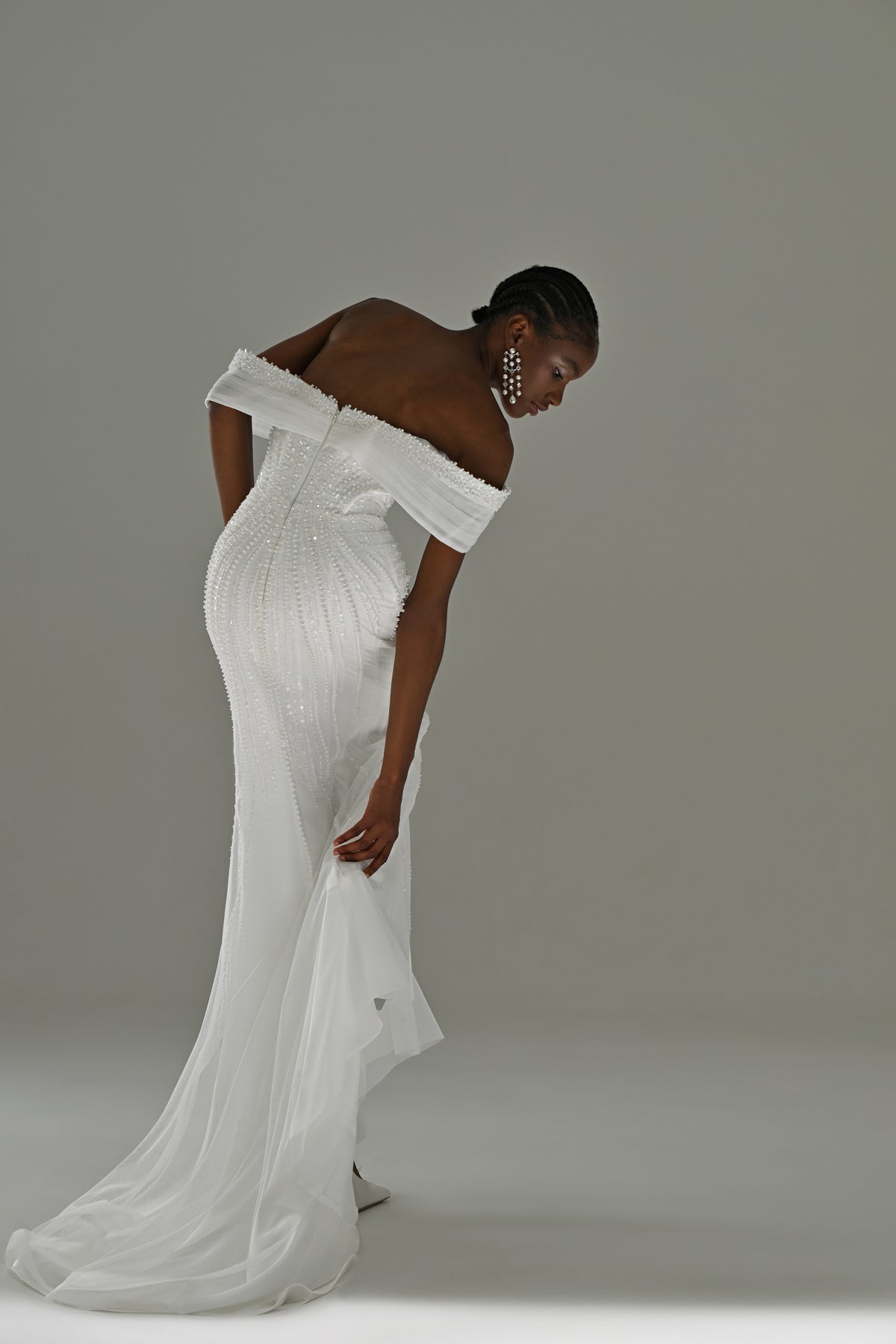Lace mermaid wedding dress with off-shoulder draped neckline – side view leaning forward