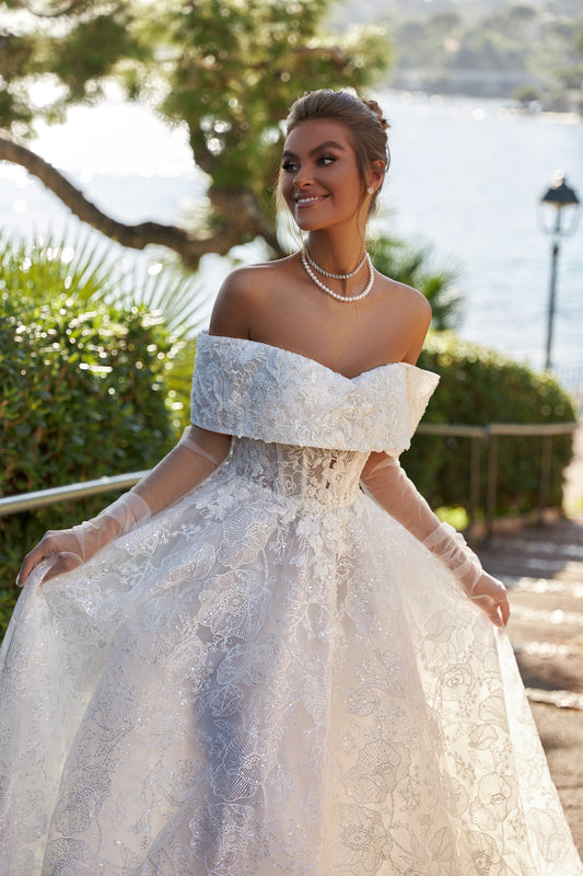 A-line lace wedding dress with chapel train & deep-V neckline.