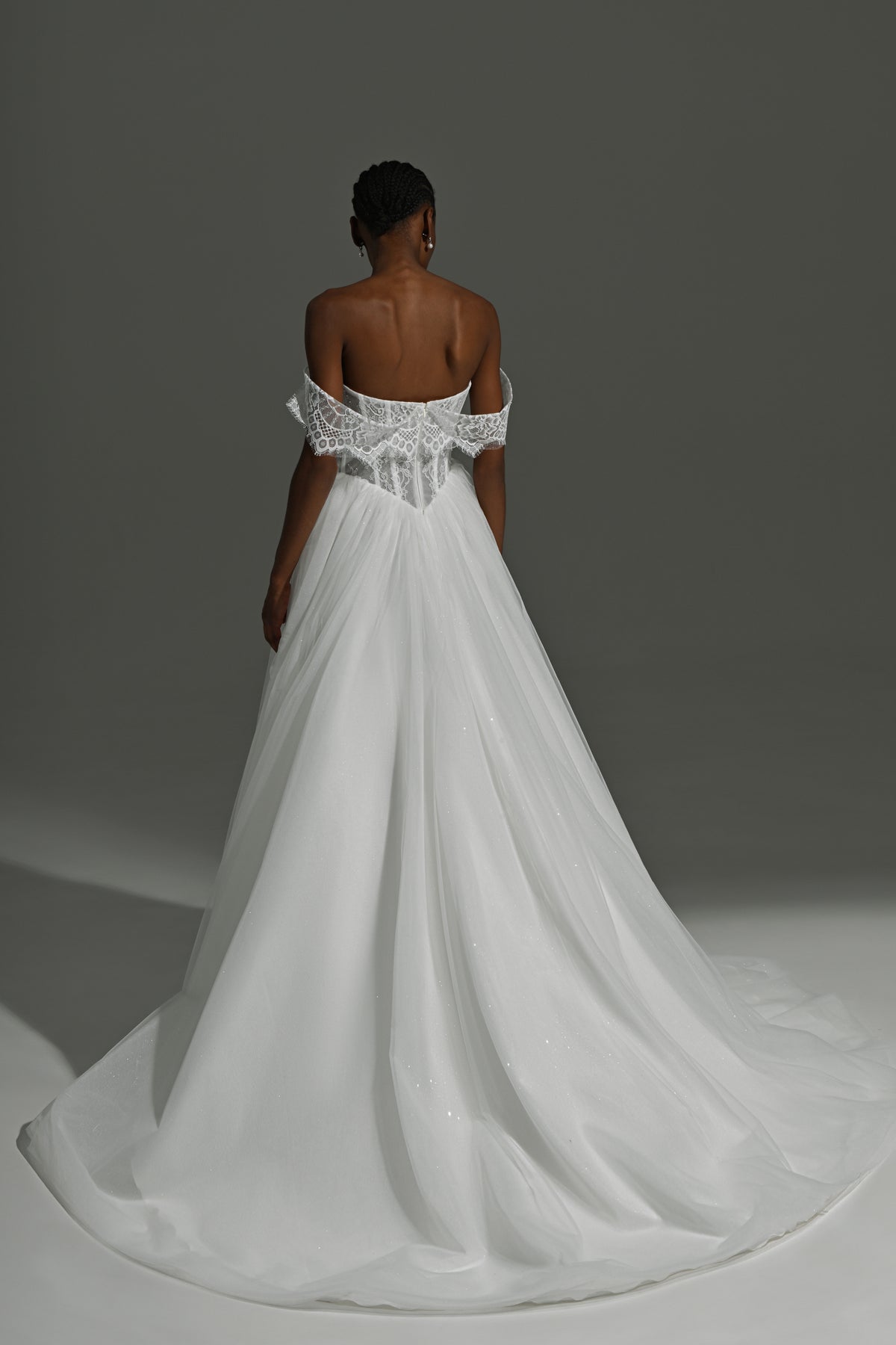 Tulle ball gown wedding dress with off-shoulder lace corset – back view with the long train