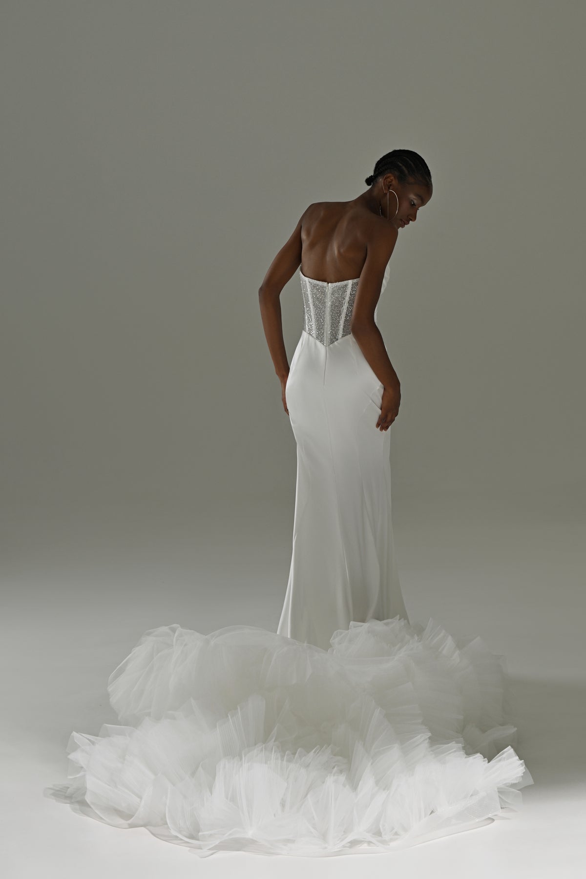 Stretch satin mermaid wedding dress – back view of the corset bodice and ruffled tulle train