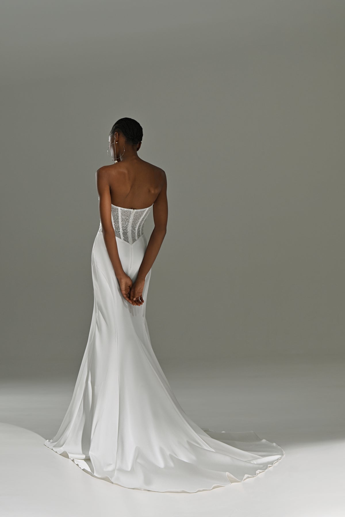 Stretch satin mermaid wedding dress – back view of the satin train, hands behind