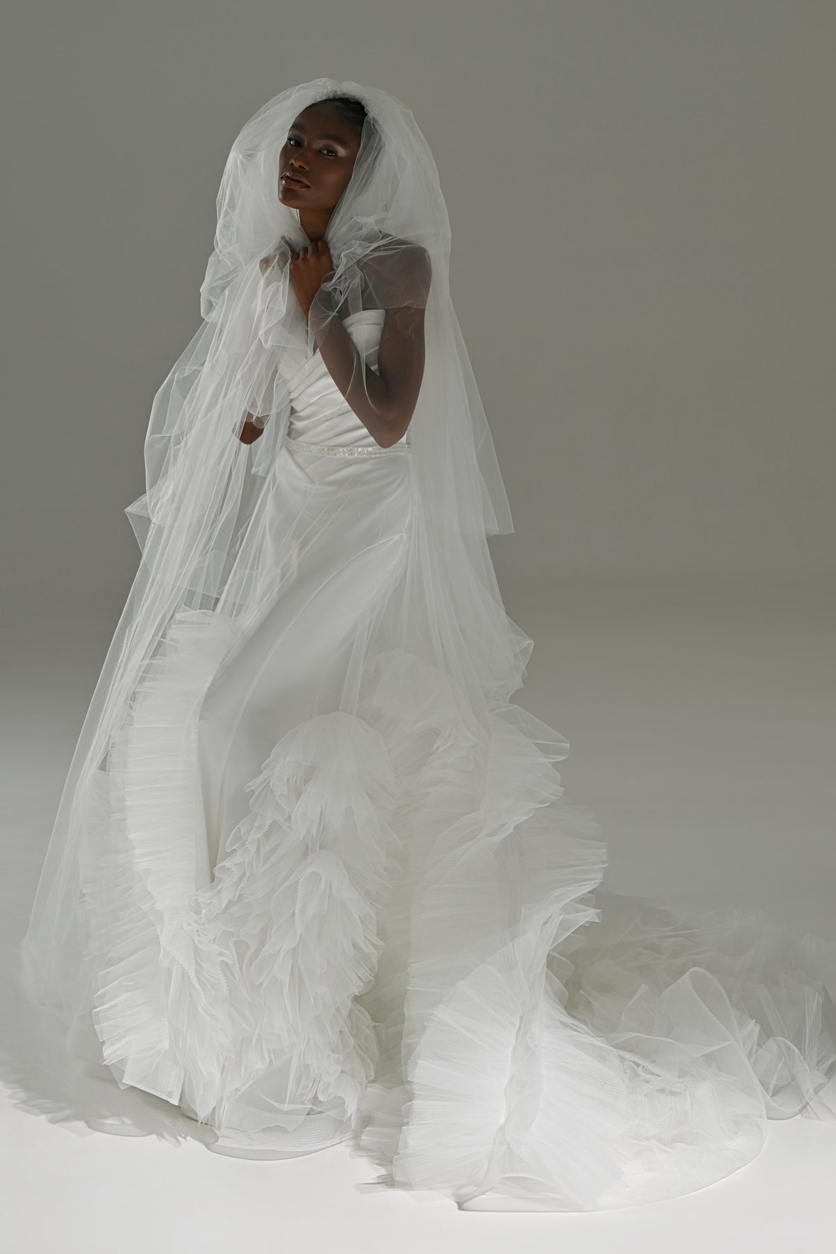 Stretch satin mermaid wedding dress with tulle skirt – front view with the veil flowing