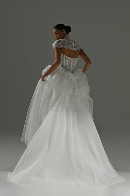 Tulle wedding dress with lace corset bodice and peplum frill – back three-quarter view of the peplum and skirt