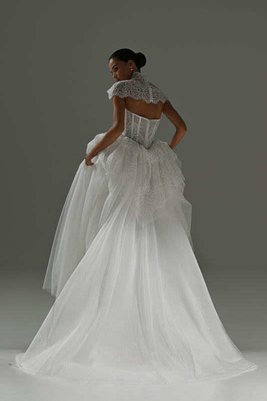 Tulle wedding dress with lace corset bodice and peplum frill – back three-quarter view of the peplum and skirt