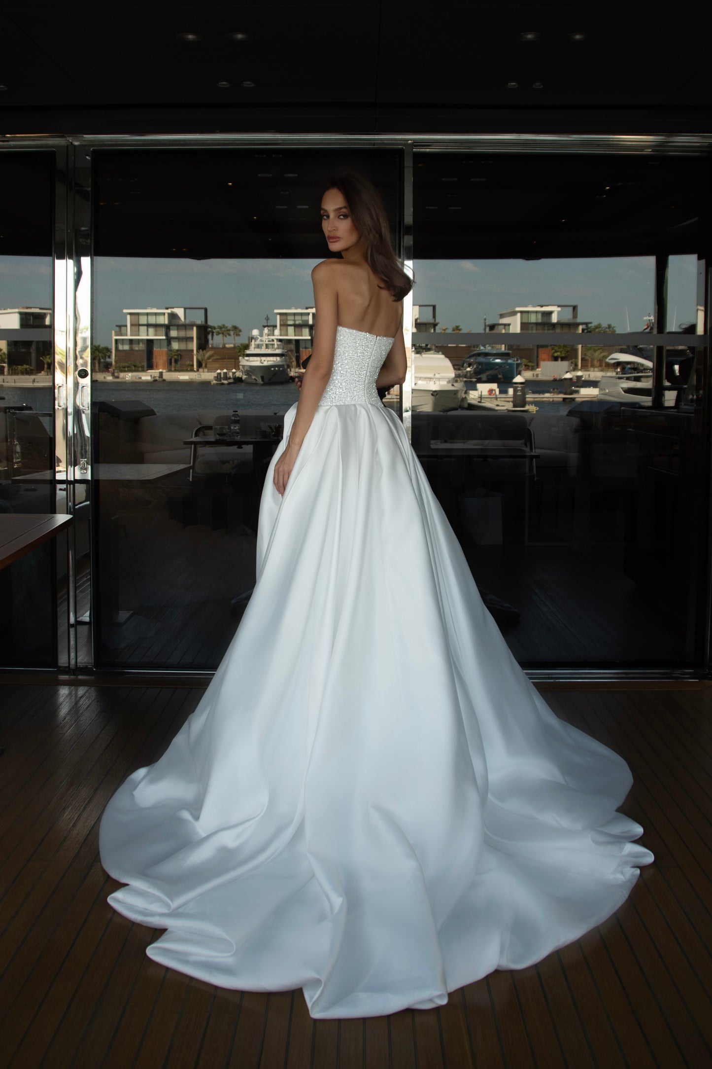 Mikado wedding gown with beaded lace corset, strapless neckline, and high slit.