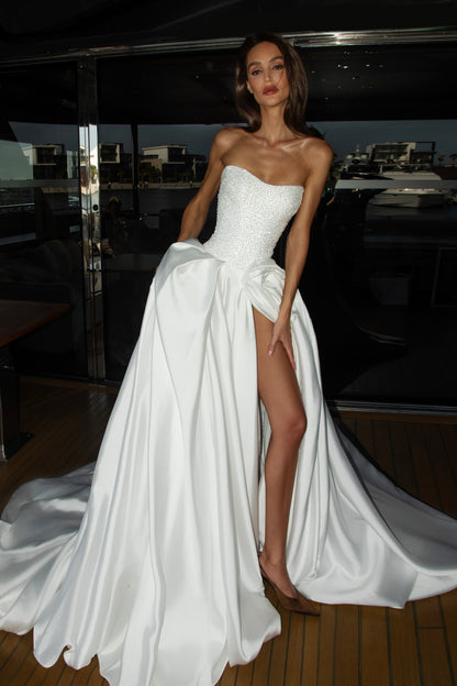 Mikado wedding gown with beaded lace corset, strapless neckline, and high slit.