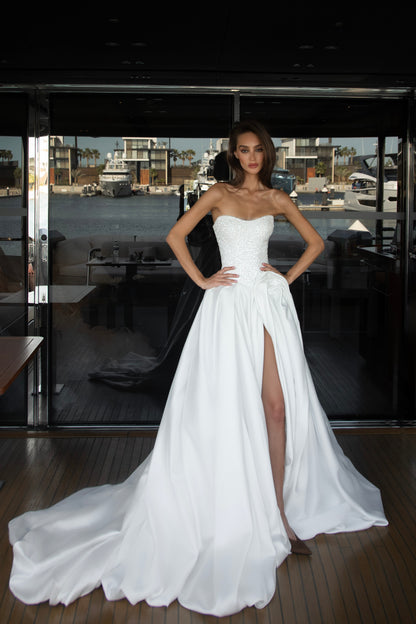 Mikado wedding gown with beaded lace corset, strapless neckline, and high slit.