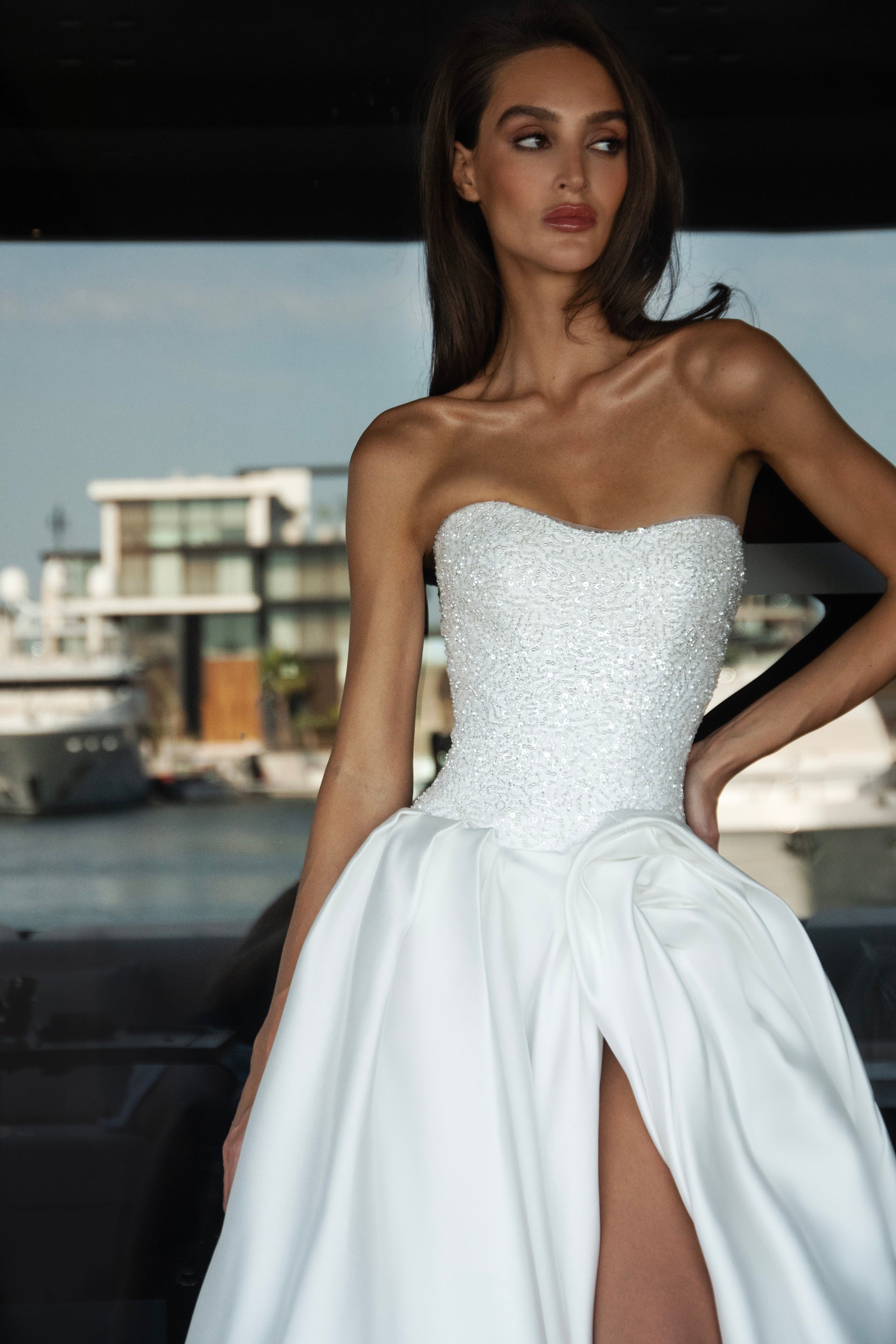 Mikado wedding gown with beaded lace corset, strapless neckline, and high slit.