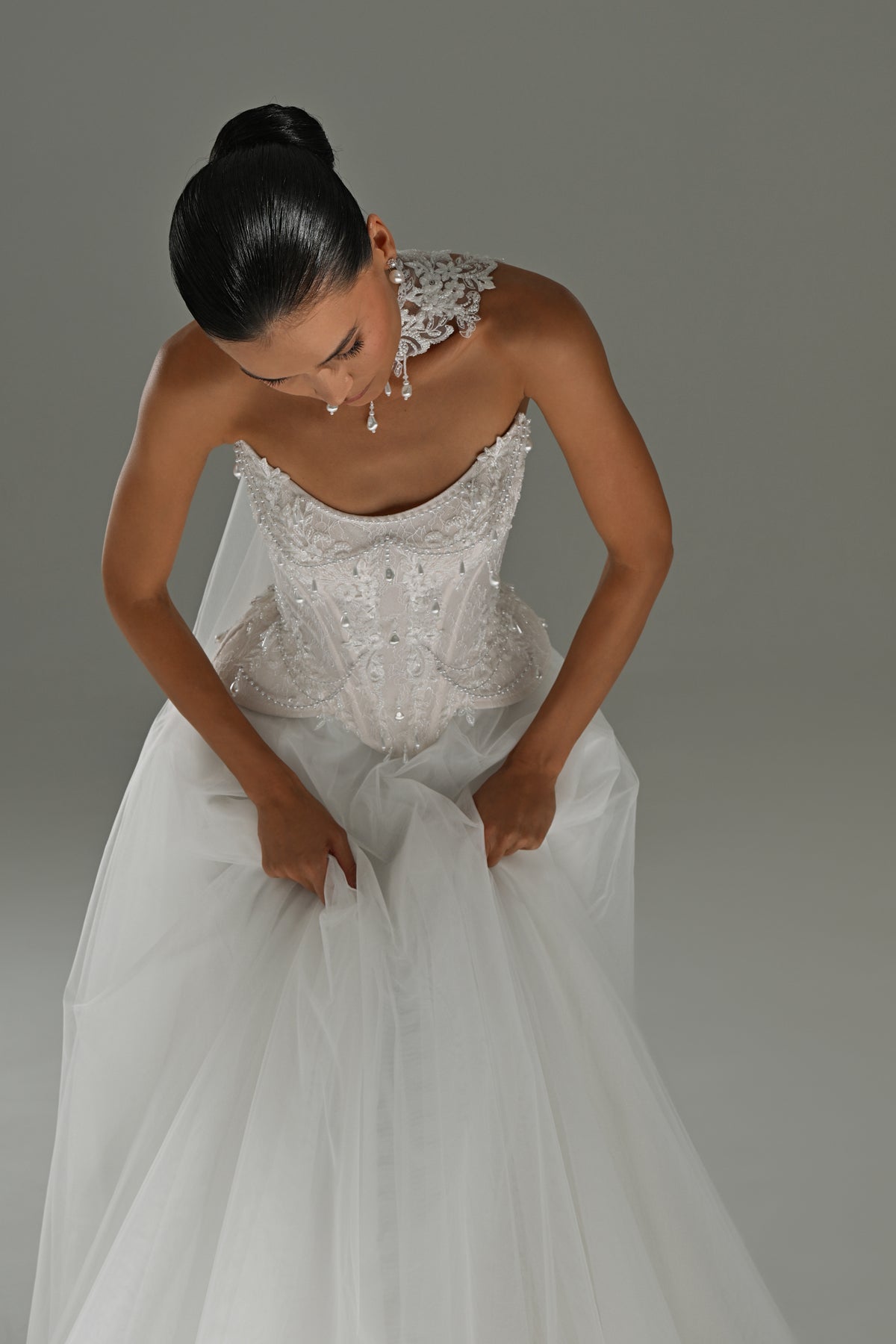 Lace corset wedding dress with choker collar – leaning forward, close view of the lace bodice