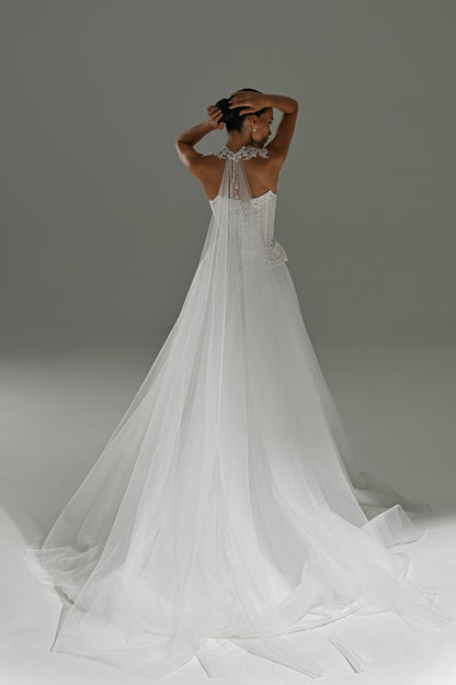 Lace corset wedding dress with removable tulle skirt – back view with arms raised and the long train