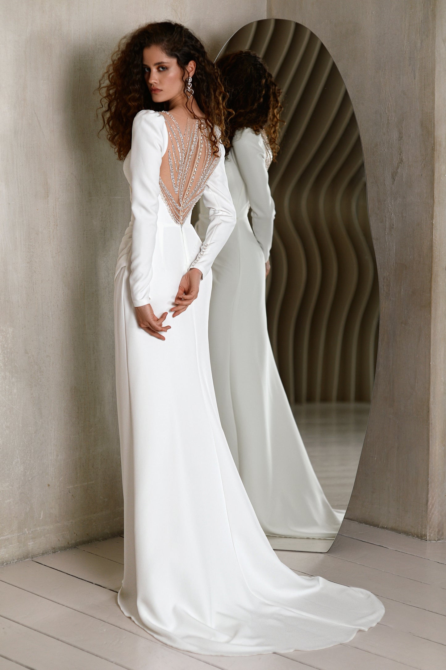 Minimalist crepe wedding dress with long sleeves and V-neckline