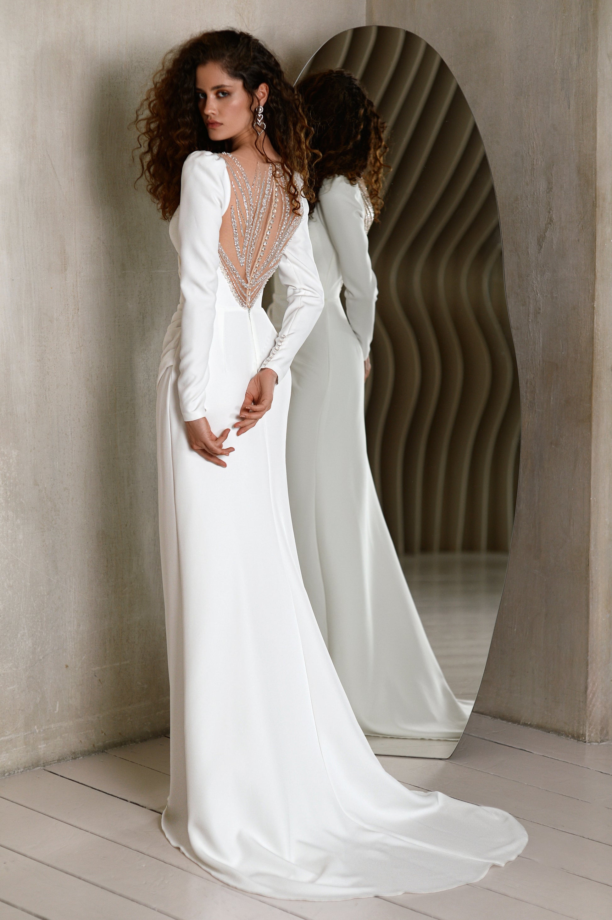 Minimalist crepe wedding dress with long sleeves and V-neckline