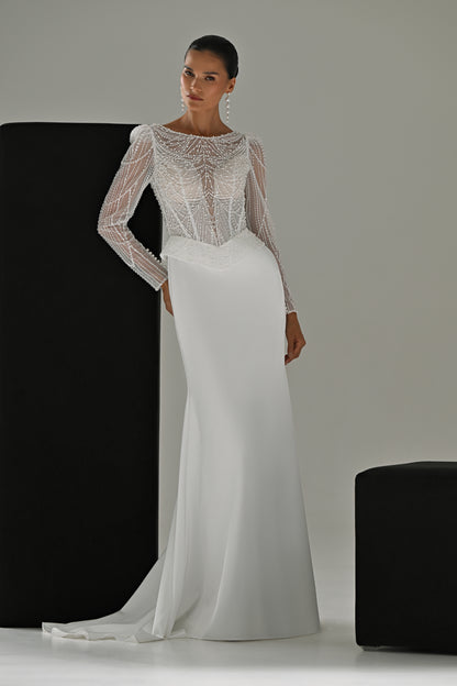 Beaded lace sheath wedding dress with illusion neckline and long sleeves – full-length front view leaning on a black block