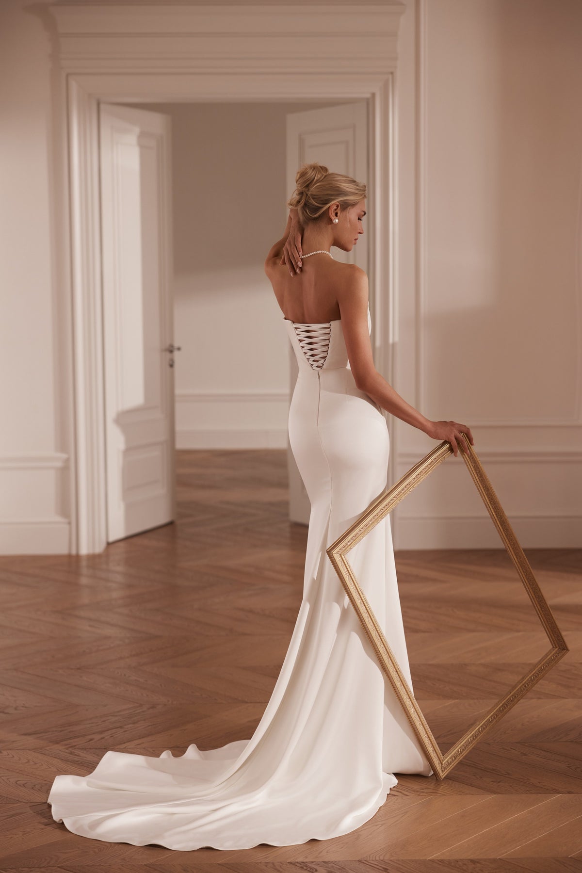Strapless mermaid crepe wedding dress with ruched bodice and lace bodysuit - back view