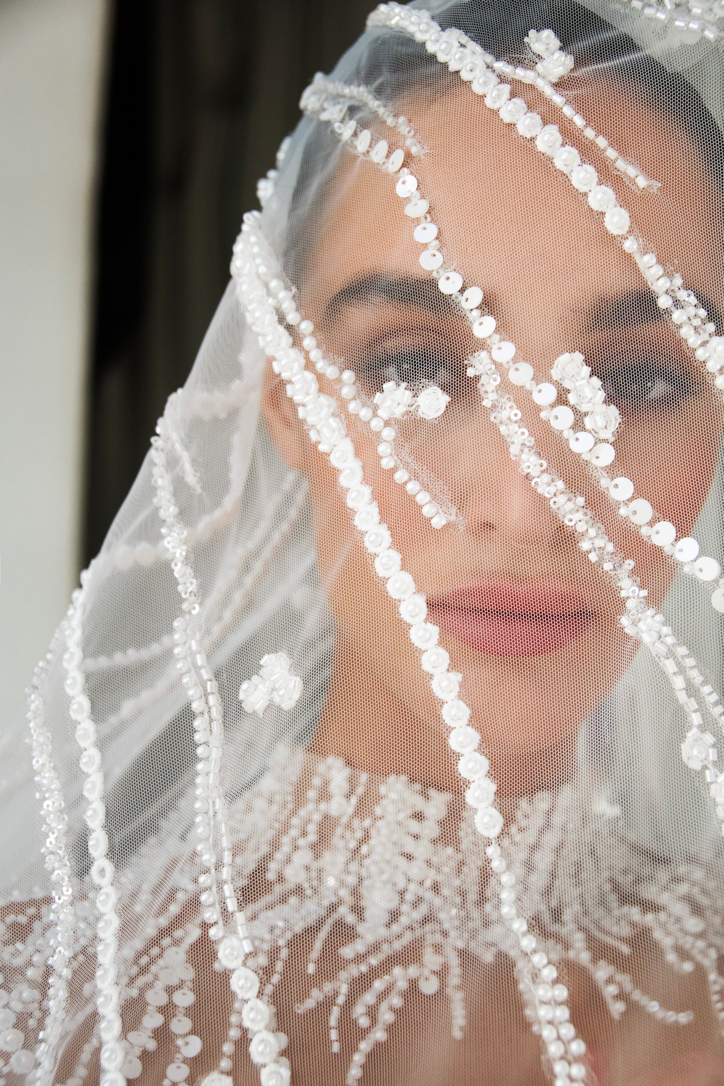 beaded A-line bridal gown with detachable illusion high-neck bolero, sheer long sleeves, button-back, and chapel train.