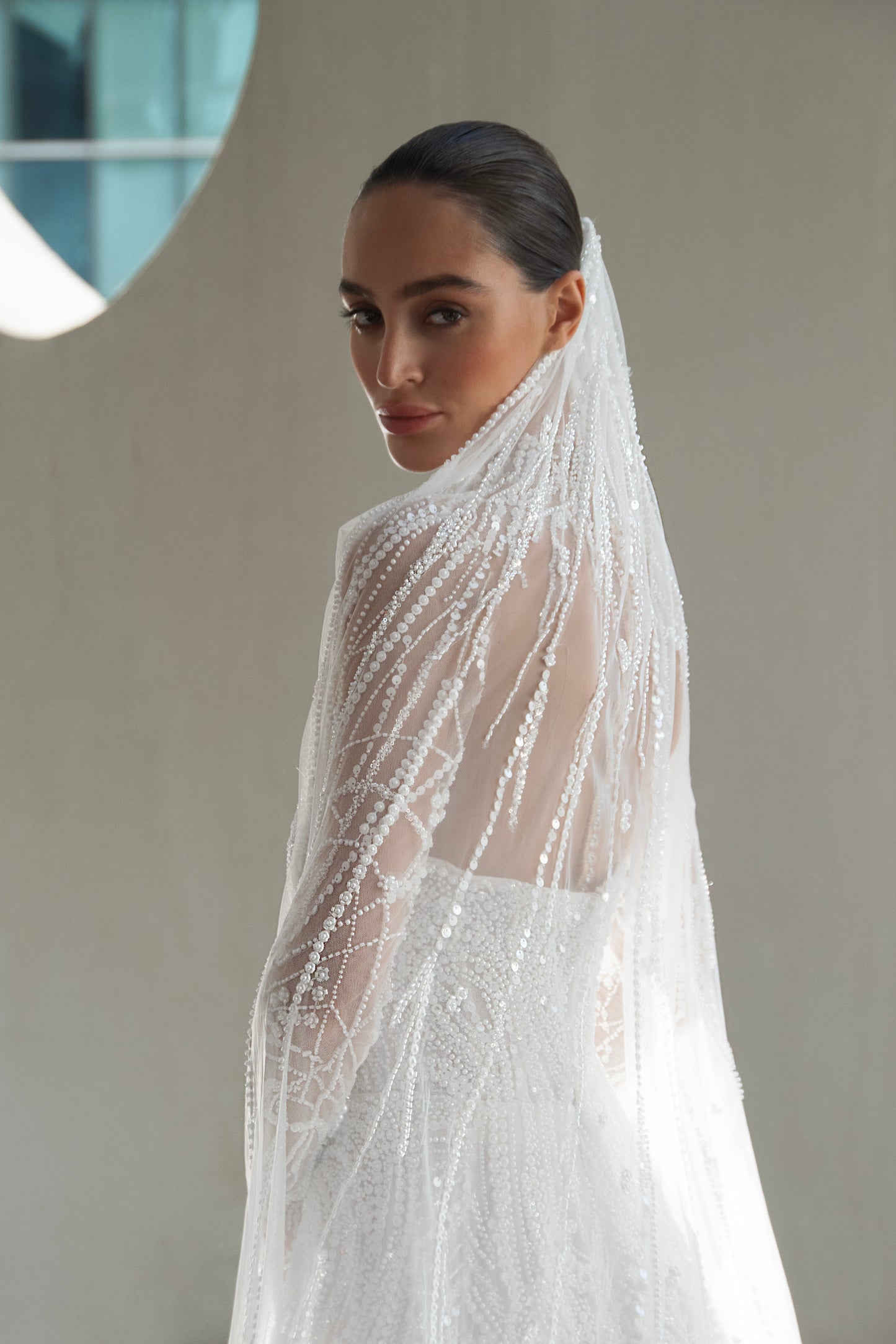 beaded A-line bridal gown with detachable illusion high-neck bolero, sheer long sleeves, button-back, and chapel train.