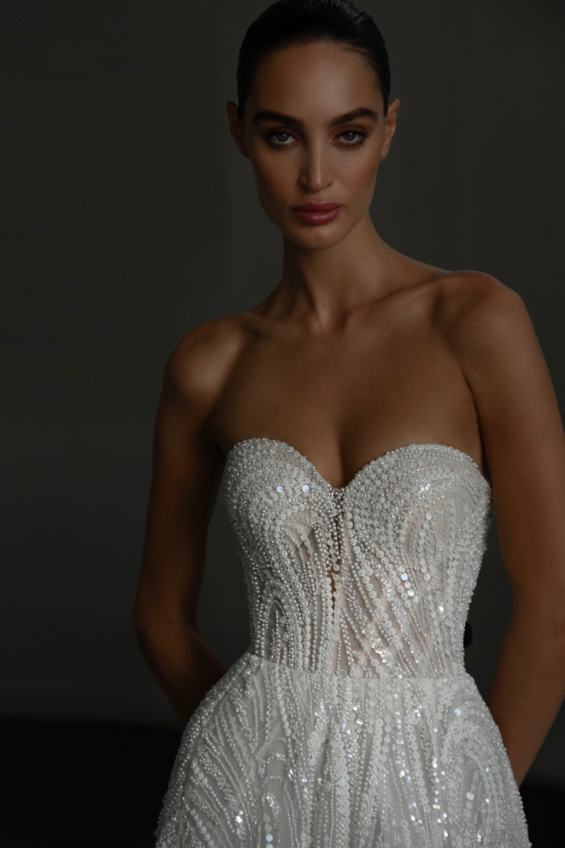 beaded A-line bridal gown with detachable illusion high-neck bolero, sheer long sleeves, button-back, and chapel train.