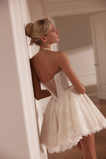 Mini lace wedding dress with pearl-embellished sweetheart corset - back view