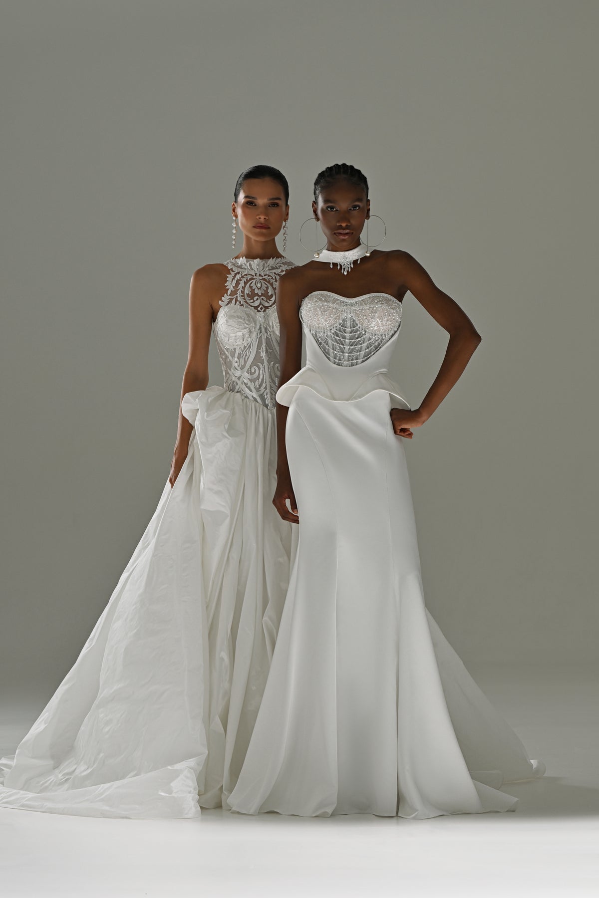 Soft satin mermaid wedding dress with lace corset and peplum waist – two brides standing together